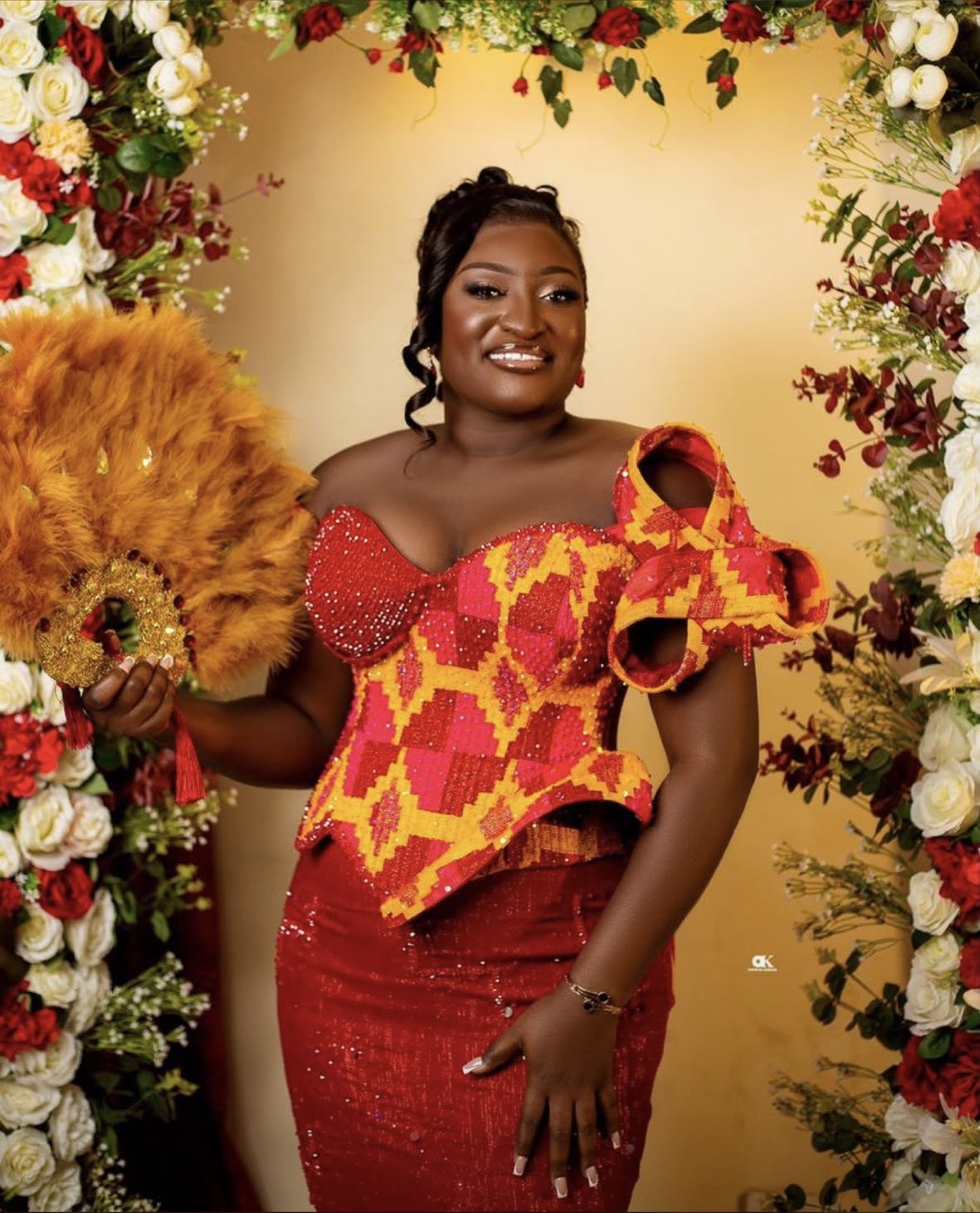 Kente corset gown with feather fan