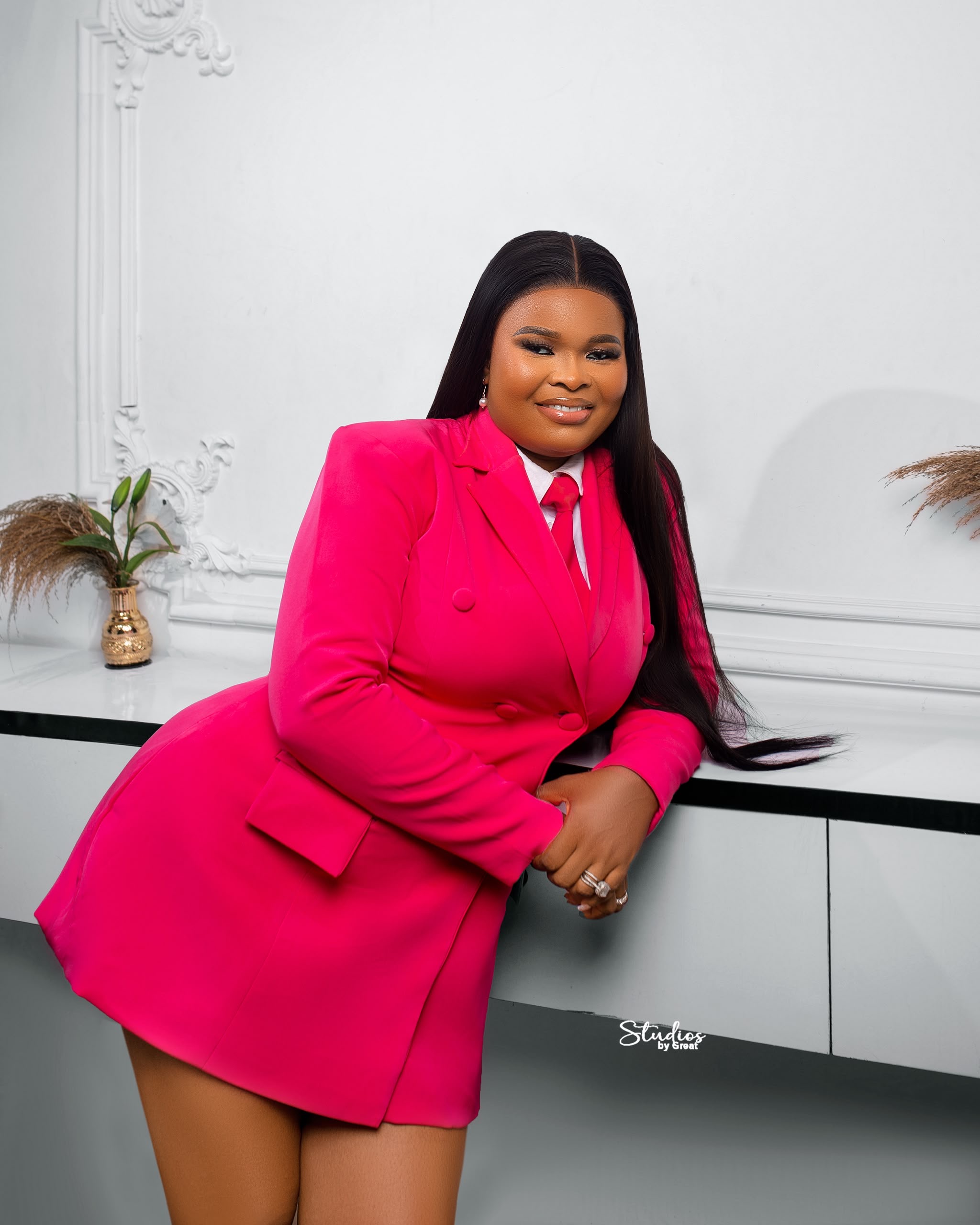 Tailored pink blazer dress, studio portrait